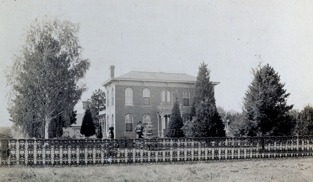 A photograph of the Gaunt family home, circa 1889, with the lawn's original cast-iron fence.
