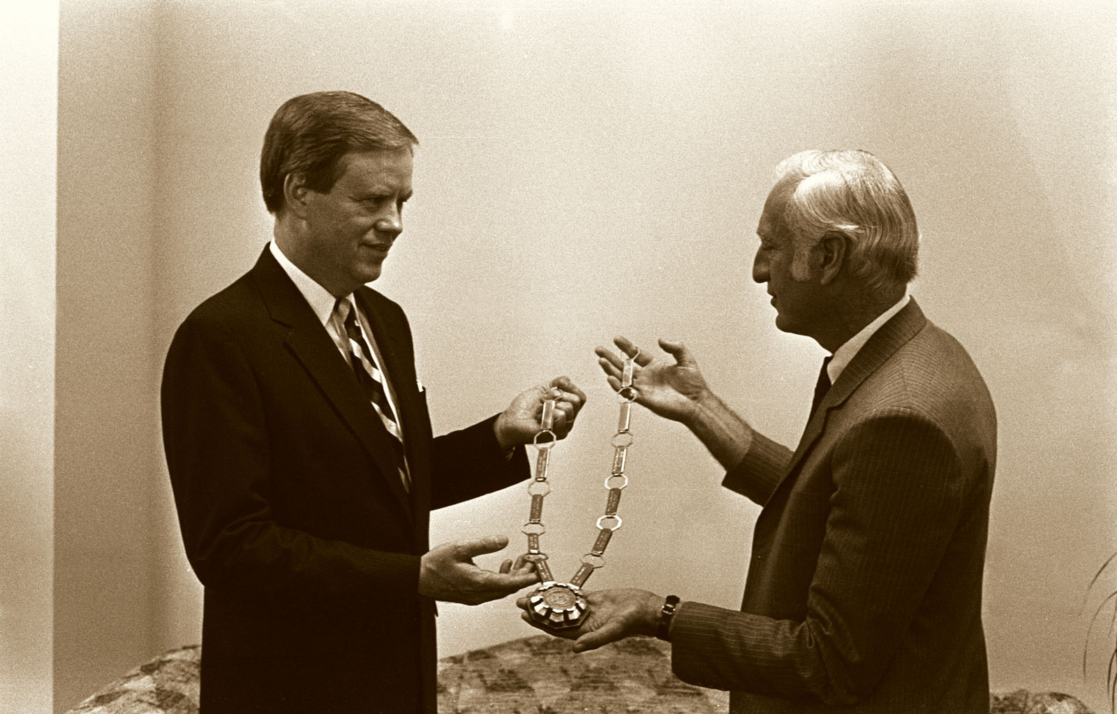 In 1984, B.D. Owens (right) presents new President Dean L. Hubbard with the Presidential Chain-of-Office, which symbolizes the Office of the President at Northwest and is worn during all formal academic ceremonies.  