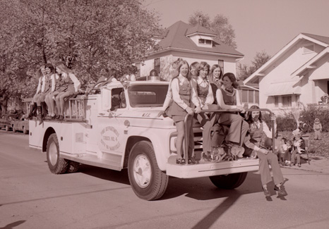 A group of Northwest sorority sisters ride on a Maryville fire truck during the 1973 Homecoming Parade to show their school spirit.
