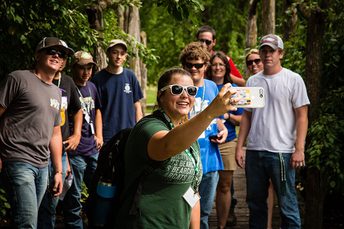 Northwest student Holly Hatfield takes a photo of her group during a GPS challenge that was part of last summer's AgriVision Equipment Group Precision Agriculture Summer Academy. The annual academy brings together 24 high school students and their high school agriculture teachers to learn about precision agriculture. (Photo by Brandon Bland/Northwest Missouri State University)