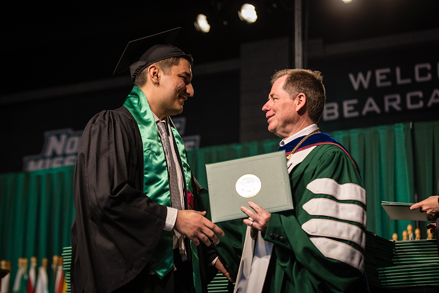 Northwest President Dr. Lance Tatum congratulates Didar Orazgeldiyev, who graduated with a bachelor’s degree in digital media with a visual imaging emphasis, on the commencement stage Friday afternoon. (Photos by Lauren Adams/Northwest Missouri State University)