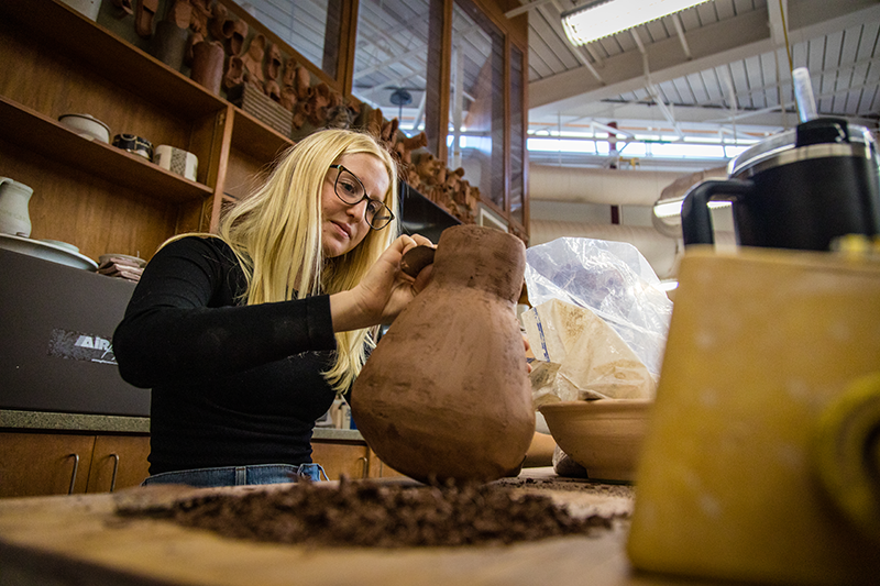 A student works on a sculpture.