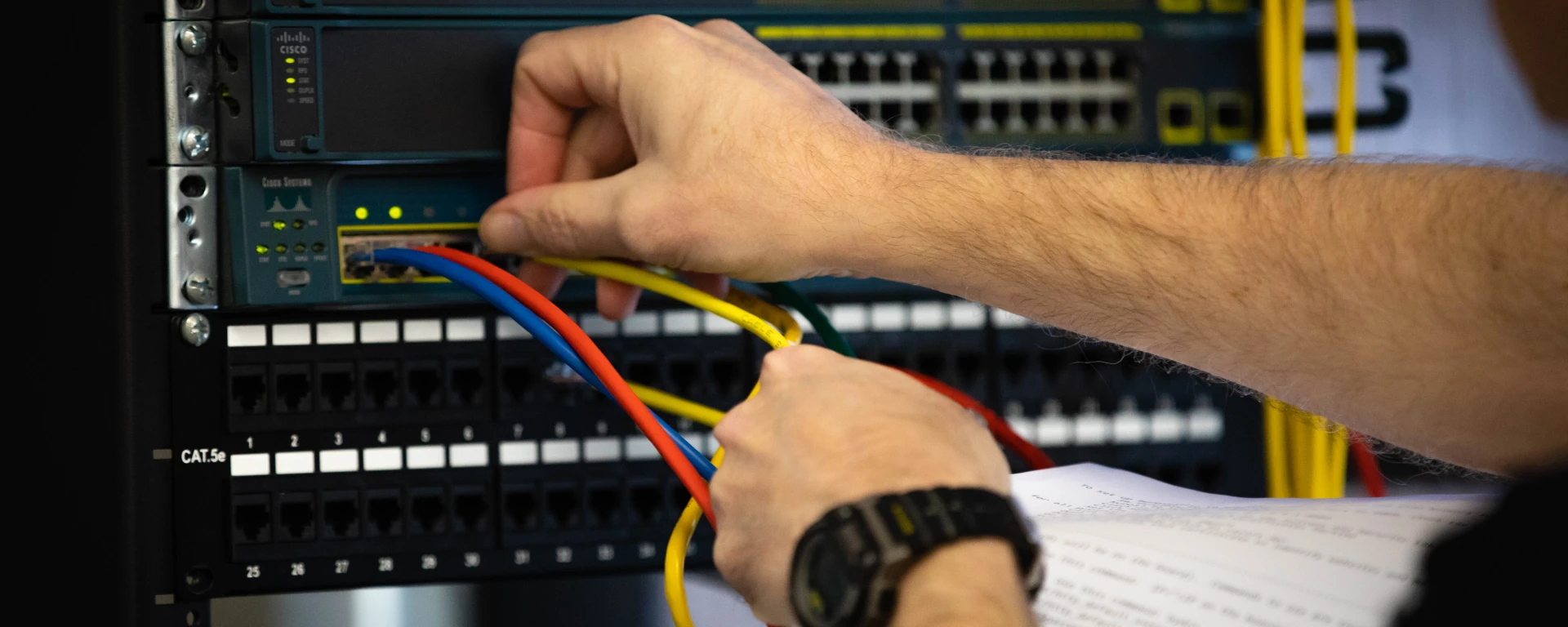 Detailed shot of Ethernet cables connected to server ports highlighting technology infrastructure