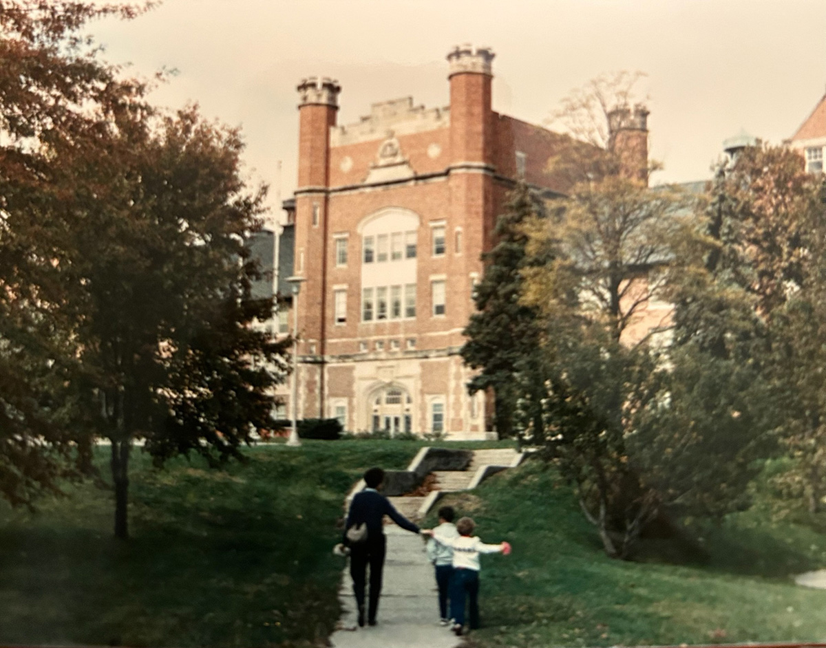 Linda Place leads Ted and his younger sister, Erin, toward the Administration Building during a walk on the Northwest campus in the early 1980s. (Place family photo)