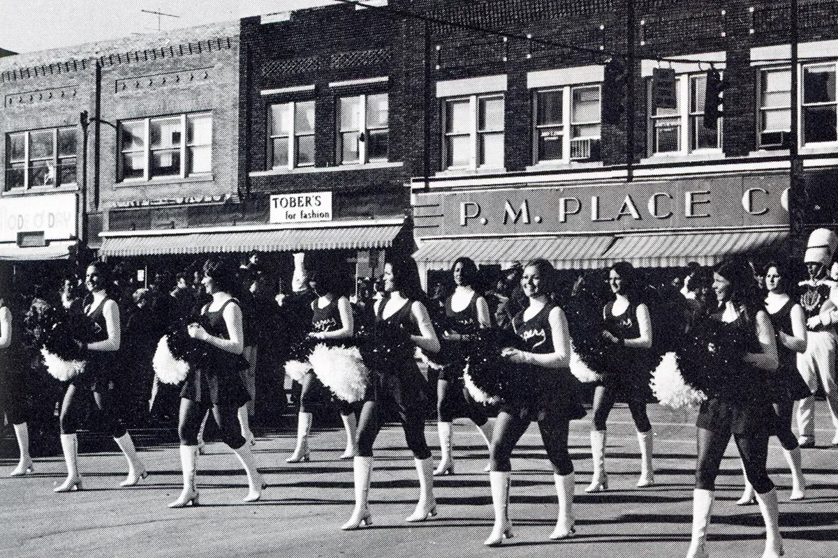 A P.M. Place Co. store stood in the background as the Bearcat Steppers and Bearcat Marching Band marched through downtown Maryville during the 1974 Homecoming parade. (Tower yearbook photo)