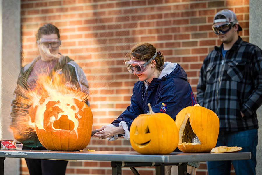 Kiersten Buck, center, served as president of Northwest's student chapter of the American Chemical Society, which lit up pumpkins outside the Garrett-Strong Science Building last fall. (Photo by Lilly Cook/Northwest Missouri State University)