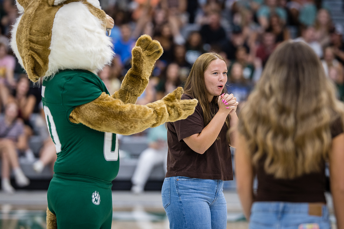 Bobby Bearcat congratulates a student as she received a prize awarded during the annual convocation at Bearcat Arena on Aug. 21. (Photo by Lilly Cook | Northwest Missouri State University)