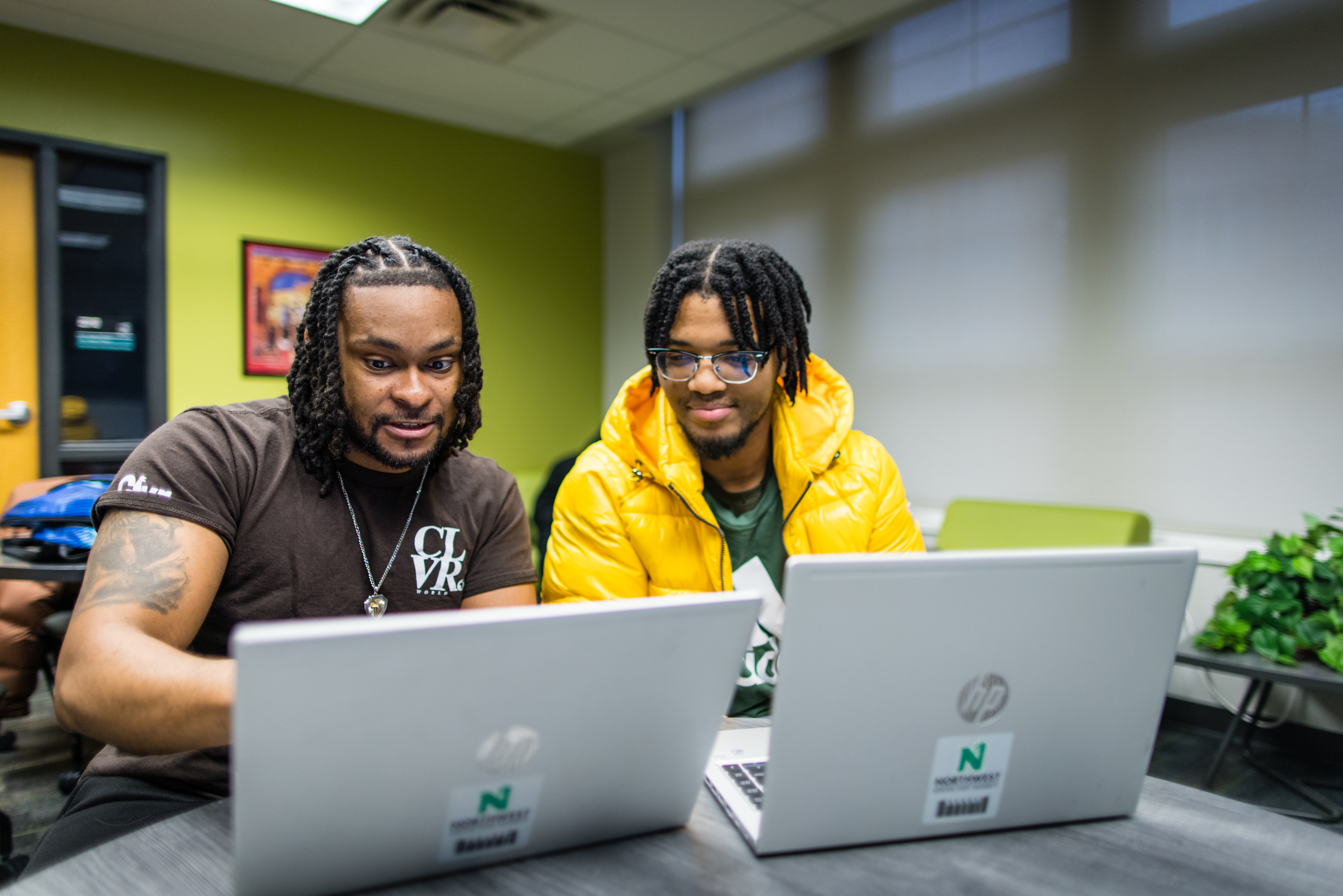 A pair of students use their Northwest laptops to collaborate inside the Office of Diversity and Inclusion.