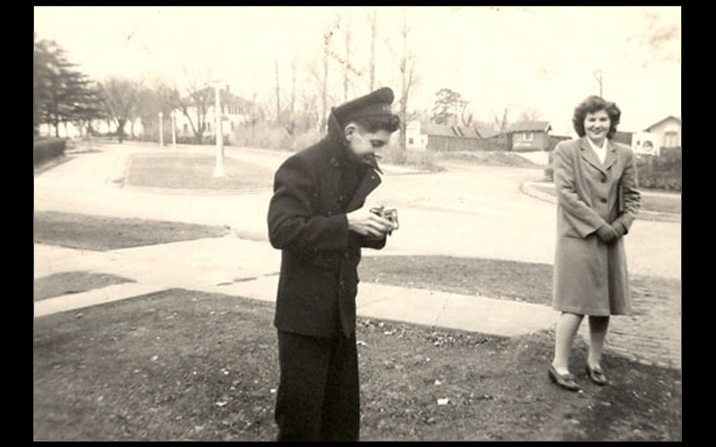 Jean and Northwest's Navy V-12 Program | Northwest 1945 graduate and computing pioneer, Jean Jennings Bartik, stands outside her Maryville residence on 4th Street chatting with one of the men in the Navy V-12 program.(Courtesy of Jean JENNINGS Bartik Computing Museum)