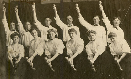 Group photo of the Normal School's first female physical education club in their physical education uniforms. In the back row are the members of the male physical education club.