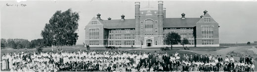 Faculty, staff, and students at Northwest Normal, including the first graduating class, pose for a group picture in front of the Administration Building in 1915.