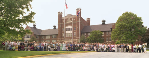 Staff and faculty at Northwest Missouri State University pose for a group picture in front of the Administration Building in 2005 during the campus Centennial celebrations.