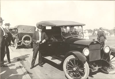 President Lamkin gets into an automobile outside the Administration Building circa 1928. Lamkin was able to obtain the Navy V-12 officer training program, which brought federal funding and hundreds of young Navy recruits to Northwest when enrollment had fallen drastically, saving the school from closing its doors.