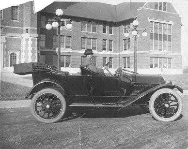Richardson sits in his automobile outside the Administration Building.  Richardson nurtured the Normal into a Teacher's College and successfully lobbied the state for a $200,000 appropriation to build a women's residence hall (known today as Roberta Hall).