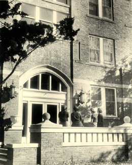 Built during the Teachers School years, the Women's Residence Hall was the only dormitory for women on campus.  Several women chat outside the front entrance of the residence hall several days prior to a tragedy that would result in the death of a student and eventually lead to the renaming of the hall to honor the student. 