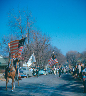 Crowds line a Maryville street during the 1952 Northwest Homecoming Parade.  The Northwest Band was always a popular spectacle at the yearly event.