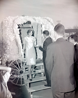 The Tower Queen descends from her carriage to help kick-off the start of the 1962 Homecoming Football Game at Northwest.