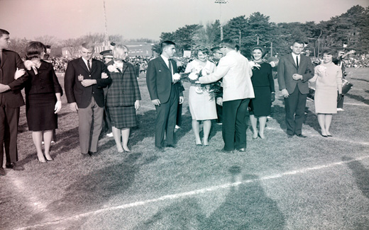 The 1962 Tower Homecoming Queen and Royal Court receive bouquets and corsages prior to start of the Homecoming Football Game.