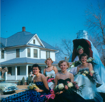 The 1952 Northwest Homecoming Queen and her royal court smile at the crowds during the Homecoming Parade.