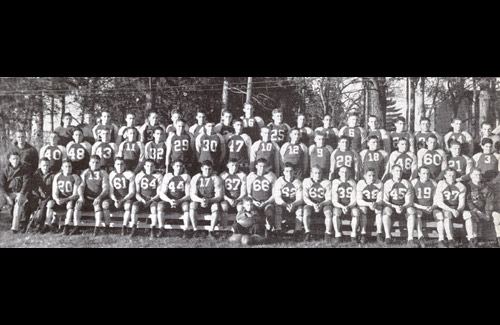 The Bearcat Football team poses for a group picture.  Milner's coaching record at Northwest was 92 wins, 61 losses, and 13 ties.