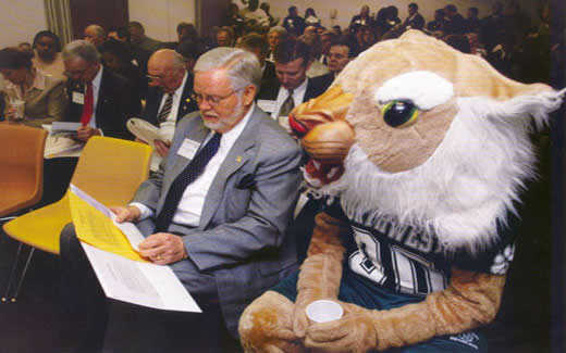 During Northwest Day at the Missouri Legislature in Jefferson City in 2004, President Dean Hubbard consults his notes as Bobby Bearcat looks on.