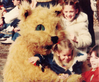 Bobby Bearcat hugs some children during the 1977 Homecoming Parade. 