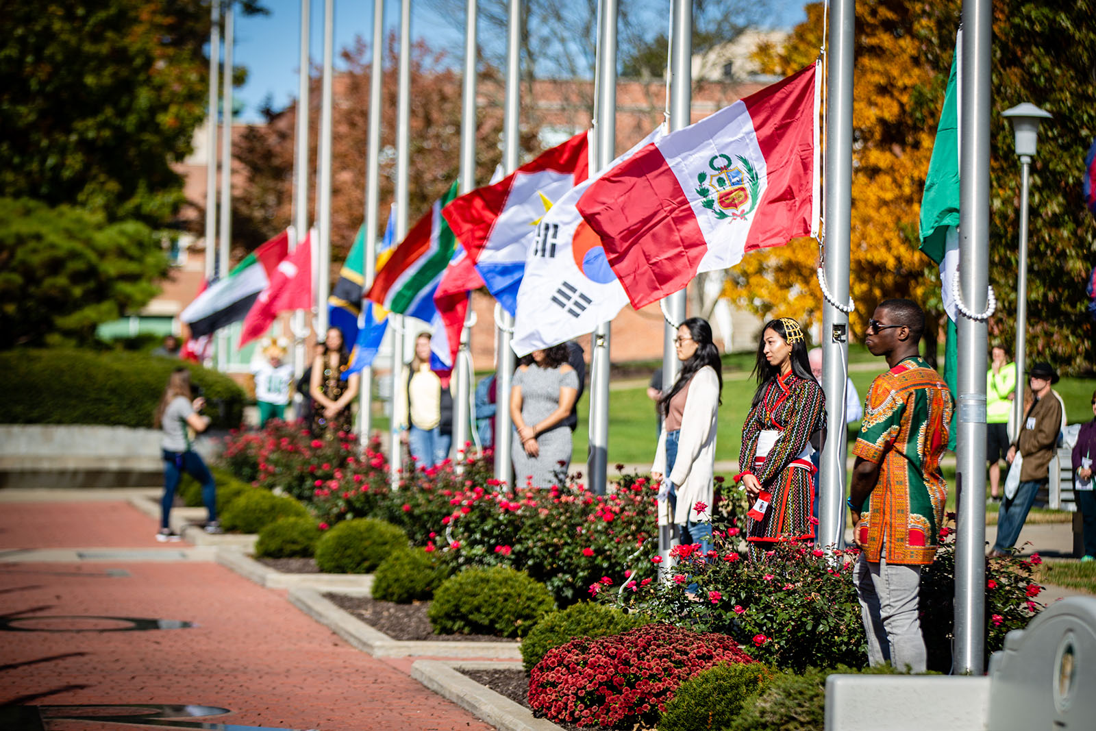 Northwest international students participate in a flag-raising ceremony during Homecoming activities each fall to celebrate their homelands and cultures as well the University’s diversity. 