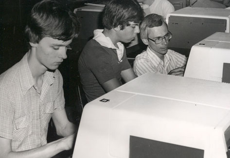 With the addition of a Computer Science degree, Northwest attracted students interested in computing and information technology.  One of the first programming classes was taught by Dr. Gary McDonald. McDonald is shown helping students in his class.