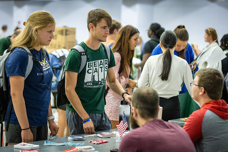 Students learning about organizations at the student org fair.