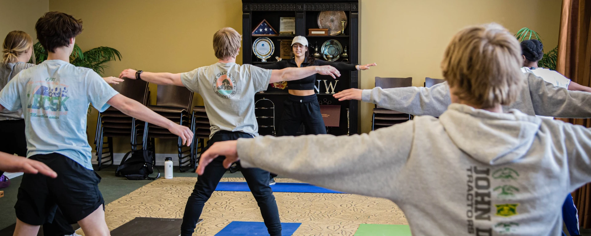 A group of students attend a yoga class to promote health and wellness