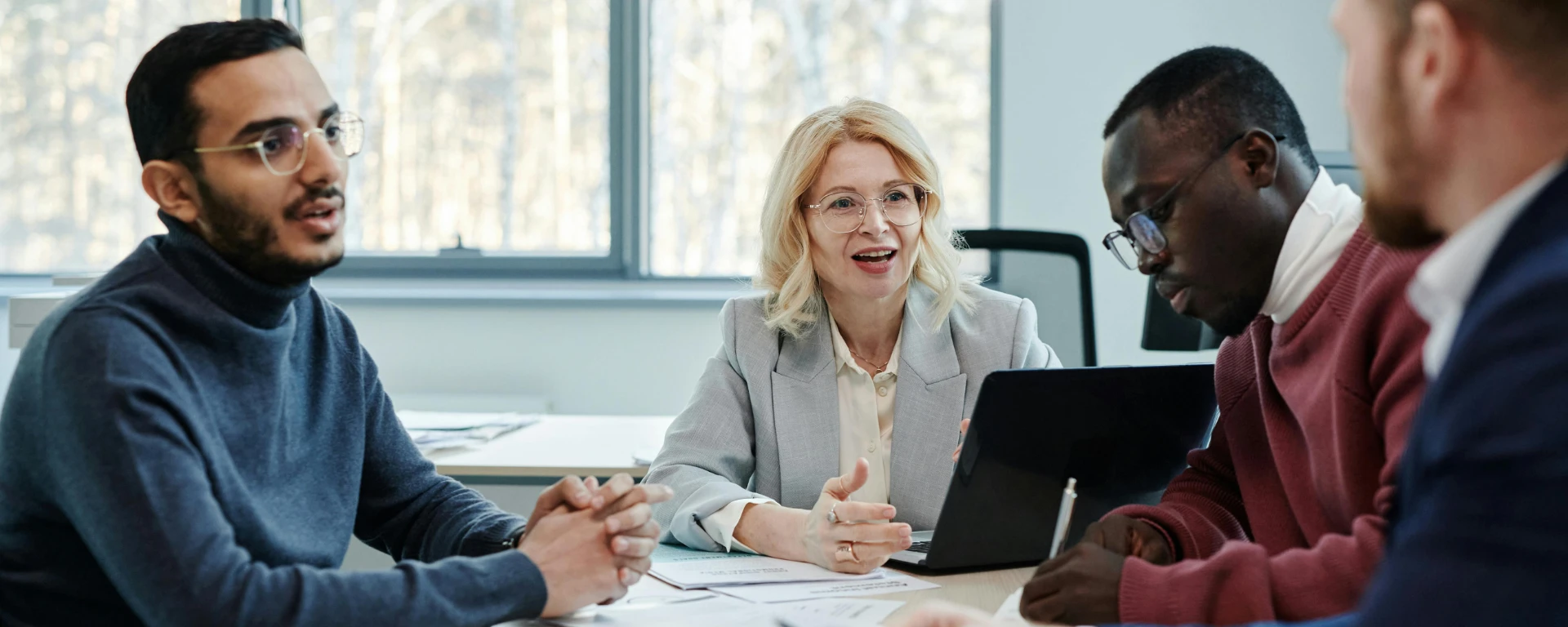 Group of professionals in a meeting discussing teamwork in an office