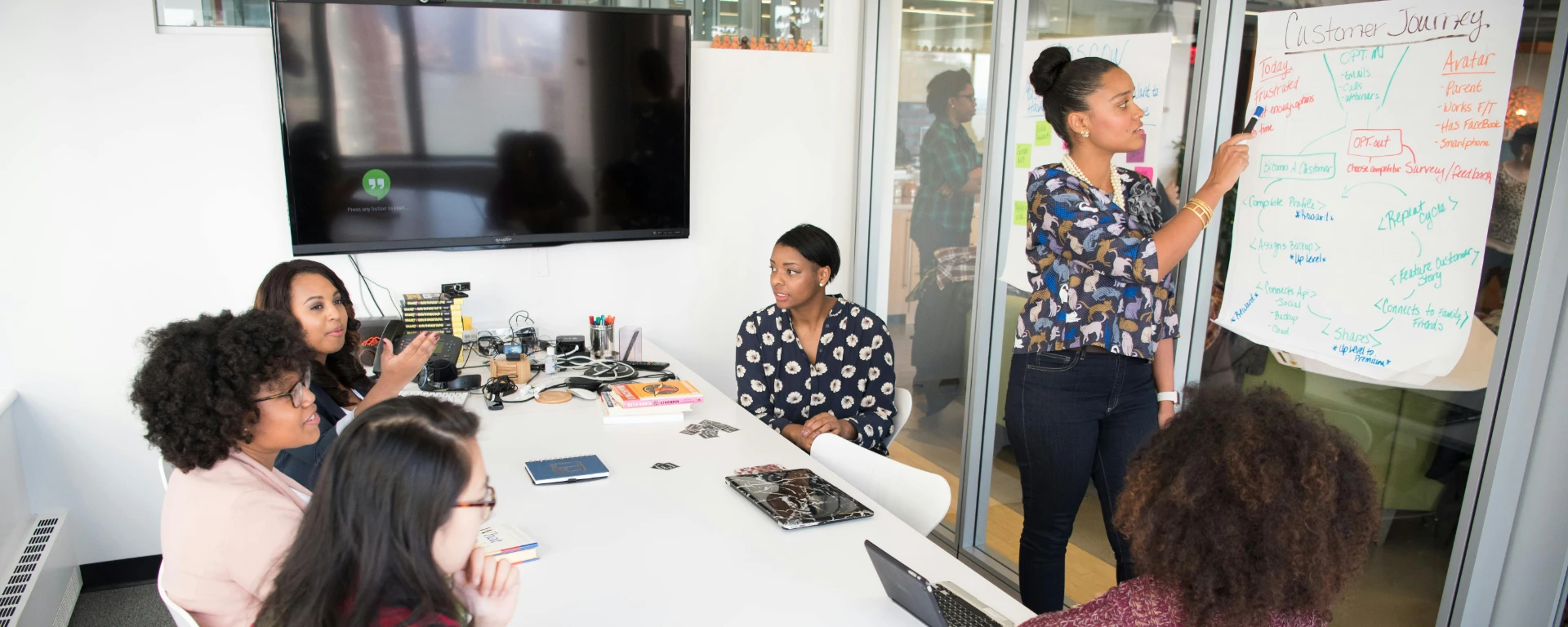 A multicultural office team engages in a collaborative brainstorming session around a conference table