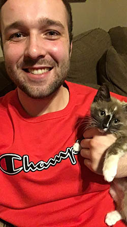 Joshua Smith holds Bella, a kitten his father rescued from a Kansas City interstate. The kitten's story was picked up by news stations and it has since gone viral. Smith shared the photo below of Bella napping on a Bearcat sweatshirt on the kitten's Instagram account. (Submitted photos) 