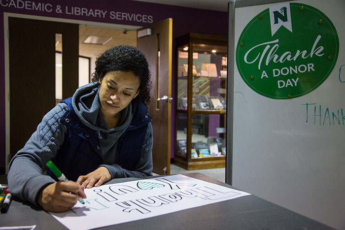 A Northwest student creates a poster during Thank a Donor activities. Northwest and its Office of University Advancement will celebrate the annual event April 2. (Northwest Missouri State University photo)