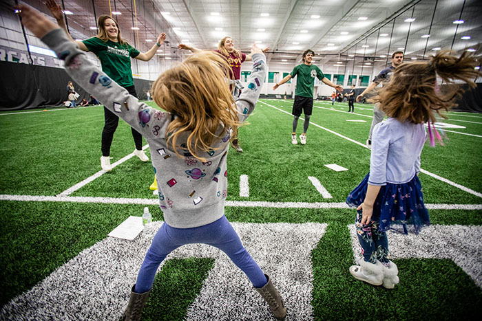 Northwest students practice jumping jacks with Horace Mann Laboratory School kindergarteners during a biomechanics class in the Carl and Cheryl Hughes Fieldhouse. (Photos by Todd Weddle/Northwest Missouri State University)