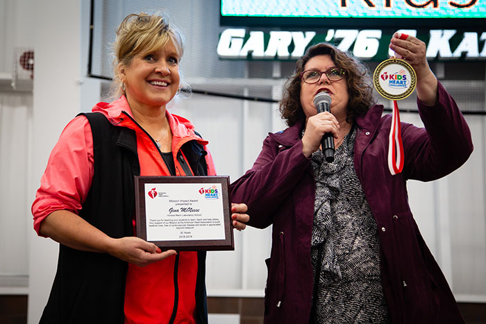 Gina McNeese accepted the American Heart Association's Mission Impact Award from Stephanie Jumps Friday as Northwest hosted the Hy-Vee Kids Fit event at the Hughes Fieldhouse. (Photo by Brandon Bland/Northwest Missouri State University)