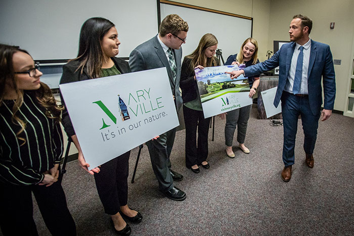 Maryville City Manager Greg McDanel reviews the promotional boards prepared by Team Exploreous after announcing the student group's marketing campaign as the winner of the 2019 Knacktive competition. (Photos by Todd Weddle/Northwest Missouri State University)
