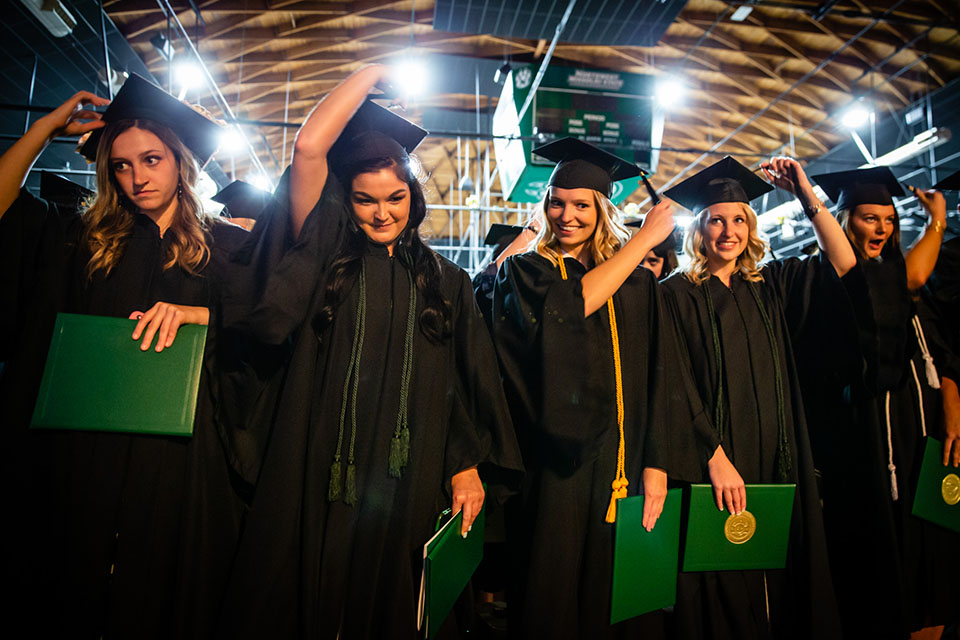 Bachelor's degree candidates representing the School of Education turn their tassel after Northwest conferred their degrees during a commencement ceremony Friday night. (Photos by Todd Weddle/Northwest Missouri State University)