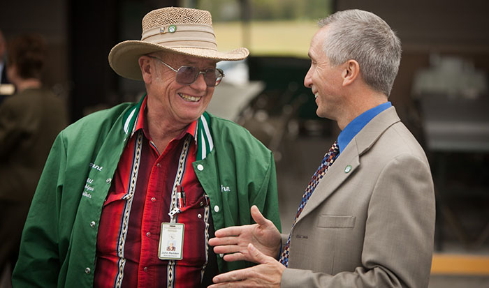John Redden converses with Northwest President Dr. John Jasinski during a gathering for Northwest employees in 2011. The University will dedicate the renaming of its Power Plant in Redden's honor during a June 11 ceremony. (Northwest Missouri State University photo) 