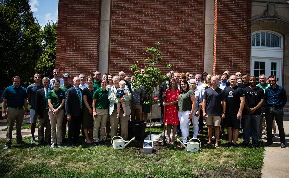 Northwest staff, faculty, and regents surround the Harr family Thursday afternoon as they honored Dr. Pat Harr and is wife, Teri, for their service to the University with a tree planted in front of Everett W. Brown Education Hall.  (Photos by Clint Brummett/Northwest Missouri State University) 