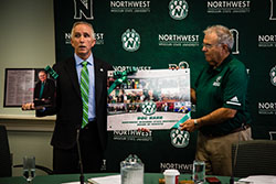 Northwest President Dr. John Jasinski presents Dr. Pat Harr, who participated in his last meeting Thursday as a member of the University's Board of Regents, with two items depicting his service to the institution, both with the Board and as a volunteer physician for Bearcat athletics teams.