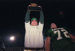 Head coach Mel Tjeerdsma raises the NCAA Division II national championship trophy after the Bearcats beat Carson-Newman in four overtimes to win their second consecutive football title. (Northwest Missouri State University photos)