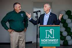 Northwest President Dr. John Jasinski discusses improvements at the R.T. Wright Farm as Rod Barr, the director of the School of Agricultural Sciences, looks on during a ribbon-cutting to celebrate the completion of a new farm manager's house. 