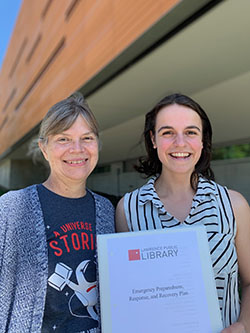 Natalie Coté (right) is pictured with Sherri Turner, assistant director of the Lawrence Public Library, after completing an emergency plan for the library. (Submitted photo) 