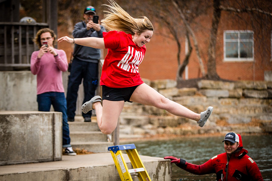 Jenna Lee-Johnson jumps into Colden Pond Wednesday afternoon during Up ’til Dawn's annual Colden Pond Plunge. Students raised $203.56 for the initiative during a Penny War. (Photo by Amanda Wistuba/Northwest Missouri State University)