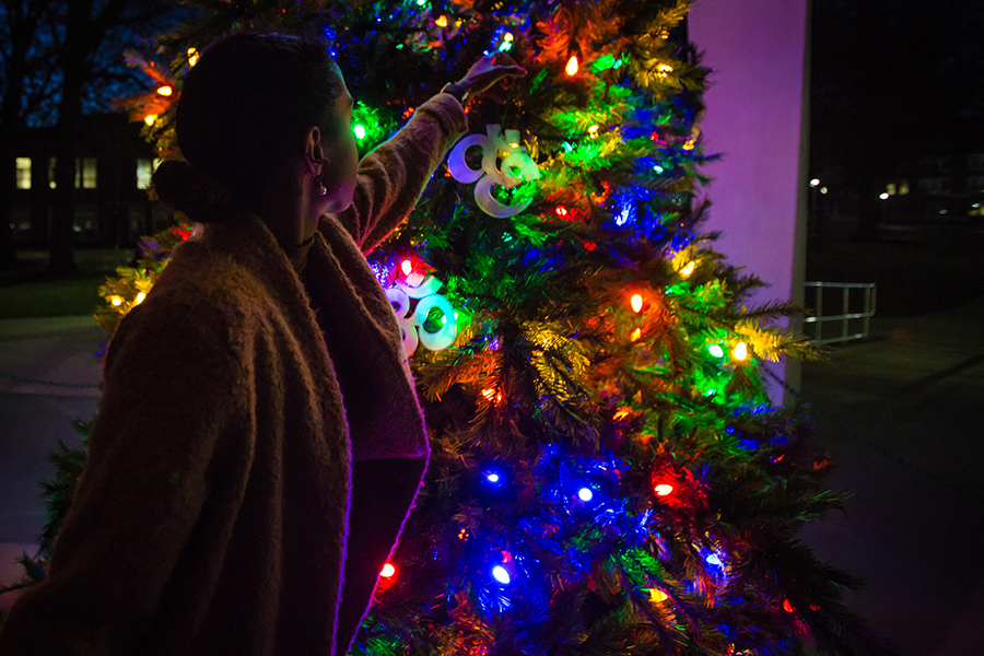 A Northwest student places an ornament on Northwest's holiday tree during the 2019 tree lighting ceremony. The Jasinski family will host this year's ceremony Nov. 18 at the Memorial Bell Tower. (Northwest Missouri State University photo)