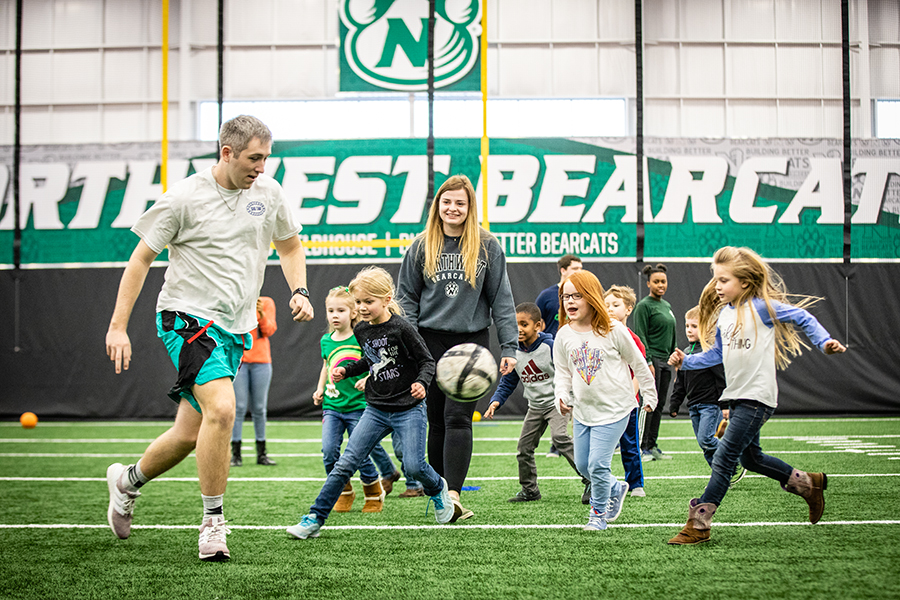 Northwest students play soccer with Horace Mann students at the Carl and Cheryl Hughes Fieldhouse. The facility will open to community members for walking and other activities during December and January. (Photos by Todd Weddle/Northwest Missouri State University)