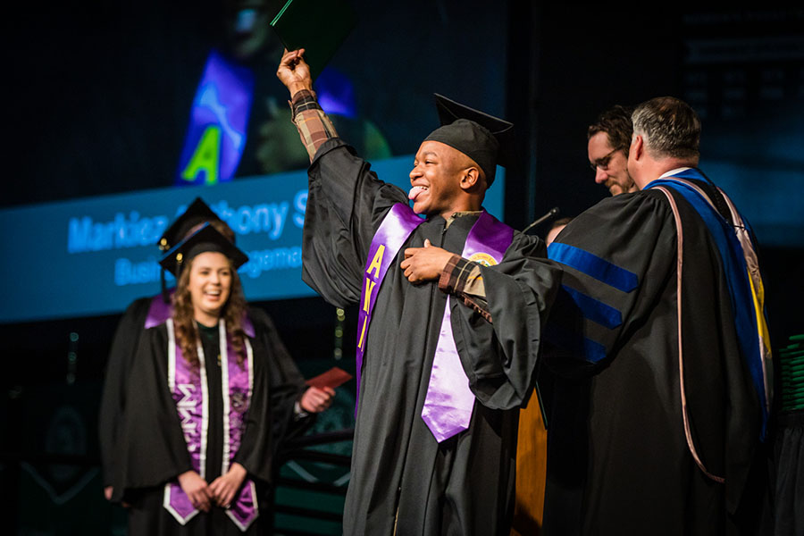 A Northwest student celebrates his graduation as he crosses the stage during the University's commencement ceremonies Friday. (Photos by Todd Weddle/Northwest Missouri State University) 