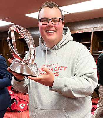 Tucker Peve, who assists the Kansas City Chiefs equipment staff, holds the Lamar Hunt Trophy after the team clinched the AFC Championship Jan. 19.
