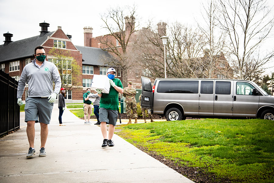 Northwest staff members unload boxes of food that were delivered to campus last week by the Missouri National Guard for students in need. Northwest received the food donations from Second Harvest Food Bank in St. Joseph. (Photo by Brandon Bland/Northwest Missouri State University)